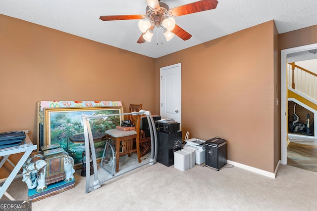 misc room featuring baseboards, a ceiling fan, and carpet