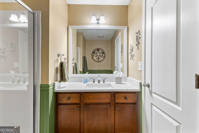 bathroom featuring vanity and a wainscoted wall