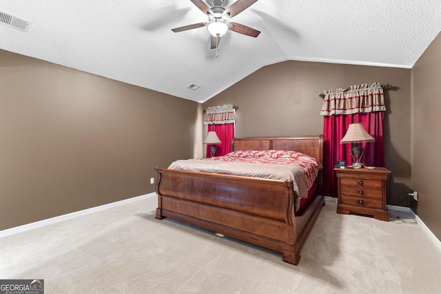 bedroom with lofted ceiling, carpet flooring, a textured ceiling, and visible vents