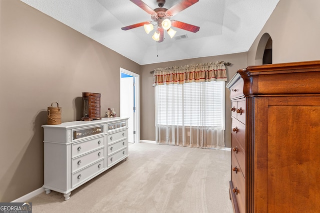 bedroom featuring visible vents, a ceiling fan, baseboards, and light colored carpet