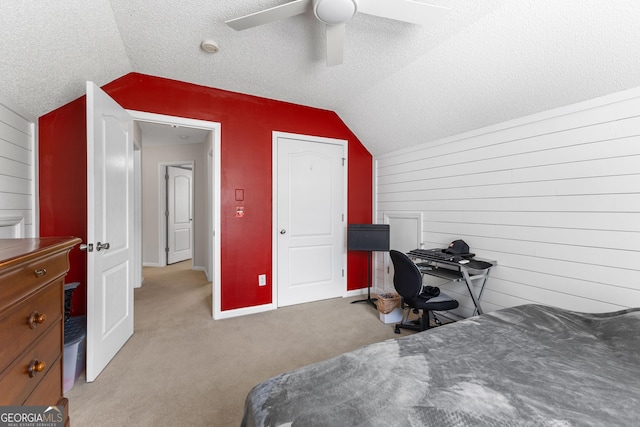 bedroom with light colored carpet, wooden walls, ceiling fan, and vaulted ceiling