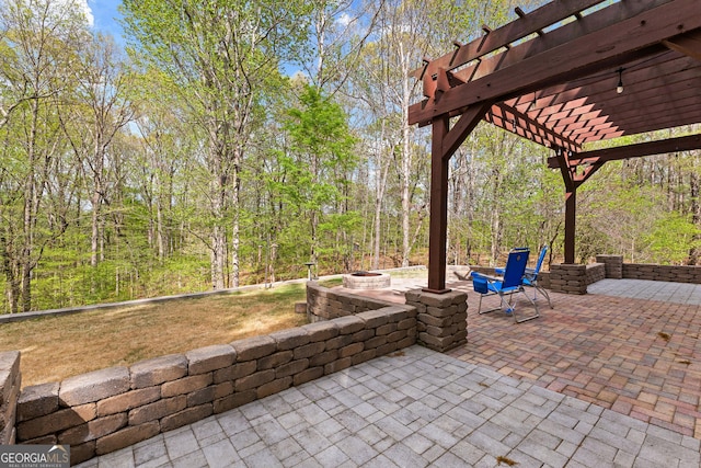 view of patio with a fire pit and a pergola
