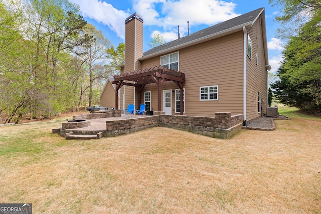 back of property featuring a patio, an outdoor fire pit, a lawn, and a pergola
