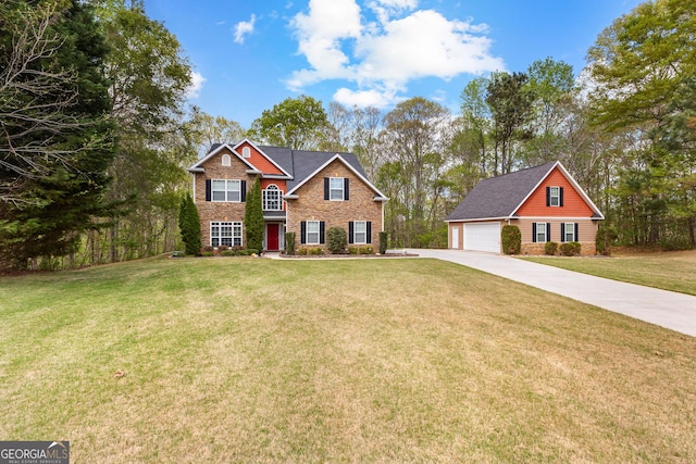 view of front of property with an outbuilding, a garage, brick siding, a front lawn, and concrete driveway