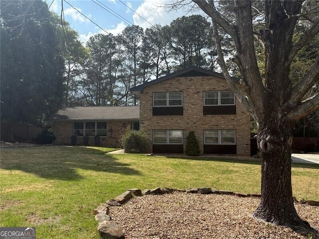 rear view of house with brick siding and a lawn