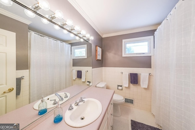 bathroom with vanity, ornamental molding, tile patterned flooring, visible vents, and tile walls