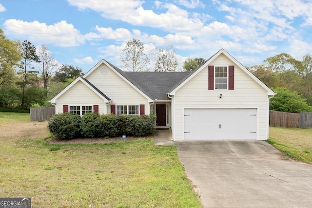 view of front facade with a front yard, driveway, and fence