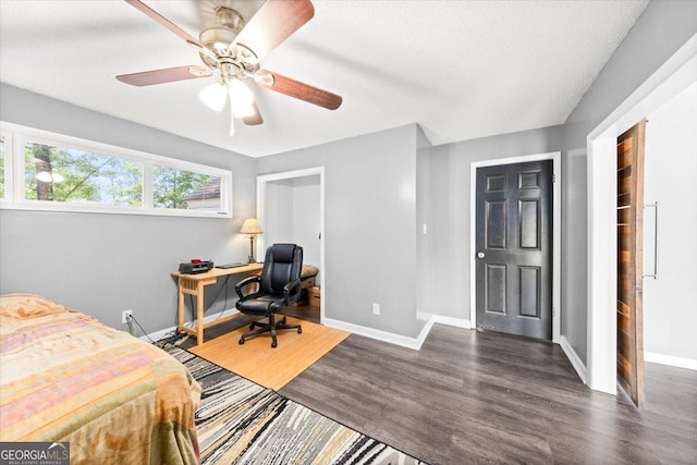 bedroom with baseboards, wood finished floors, and a ceiling fan