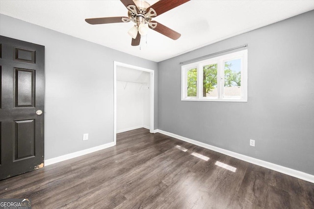 unfurnished bedroom featuring a closet, baseboards, ceiling fan, and wood finished floors