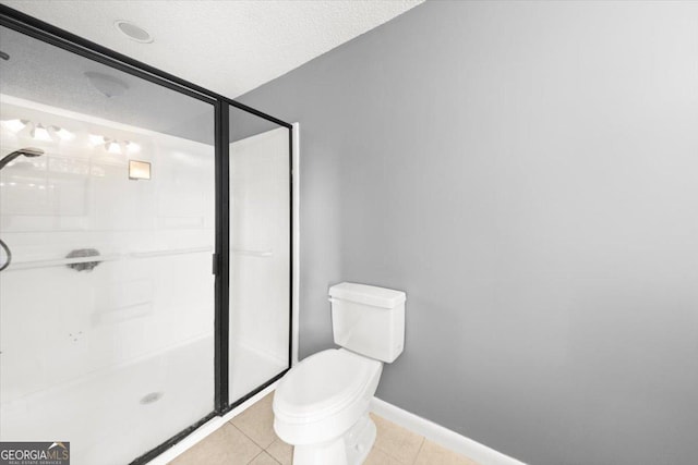 full bath featuring tile patterned flooring, toilet, a textured ceiling, and a shower stall