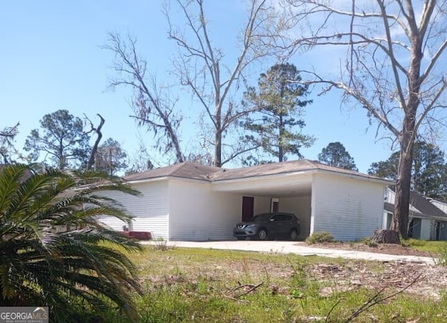 view of side of property featuring a carport