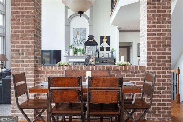 dining room with crown molding and wood finished floors