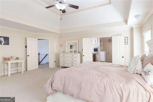 bedroom with light colored carpet, ornamental molding, a raised ceiling, ceiling fan, and visible vents