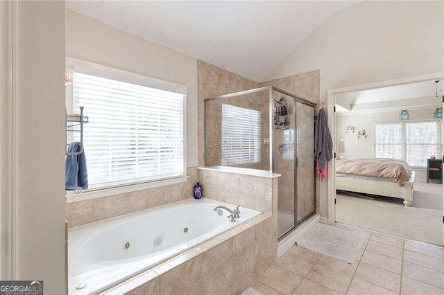 full bathroom featuring a tub with jets, a wealth of natural light, lofted ceiling, and ensuite bathroom