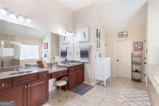 bathroom featuring a stall shower, vanity, lofted ceiling, tile patterned flooring, and tiled bath