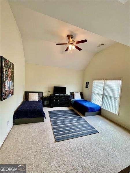 bedroom featuring high vaulted ceiling, carpet, and a ceiling fan