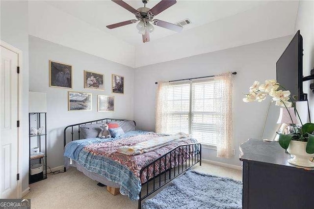 bedroom featuring baseboards, visible vents, a ceiling fan, and light colored carpet