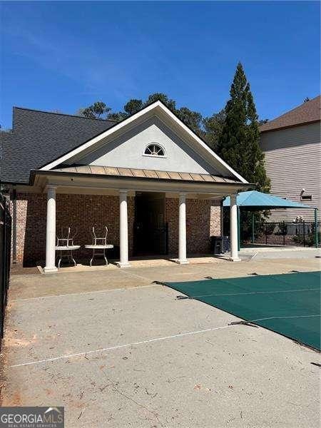 exterior space with a pool, fence, and a patio area