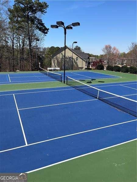 view of sport court featuring community basketball court and fence