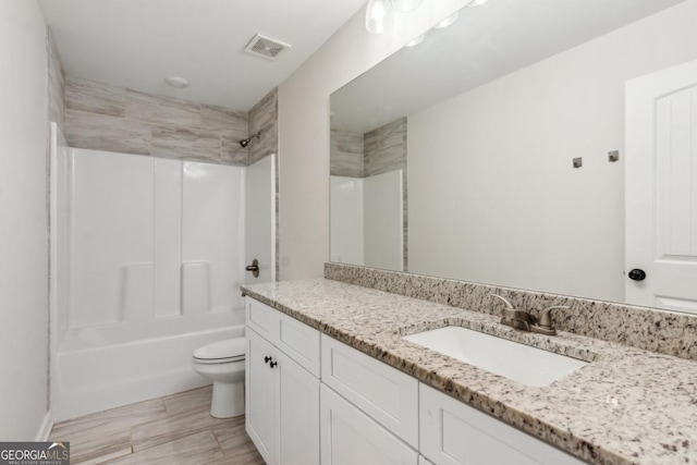 3143 Lee Cir, Buford, GA 30518 - full bathroom featuring visible vents, toilet, vanity, and shower / washtub combination