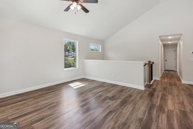 3143 Lee Cir, Buford, GA 30518 - empty room with high vaulted ceiling, baseboards, a ceiling fan, attic access, and dark wood-style floors