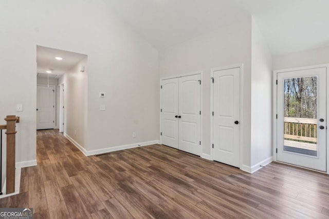 3143 Lee Cir, Buford, GA 30518 - unfurnished bedroom with attic access, wood finished floors, access to outside, baseboards, and two closets
