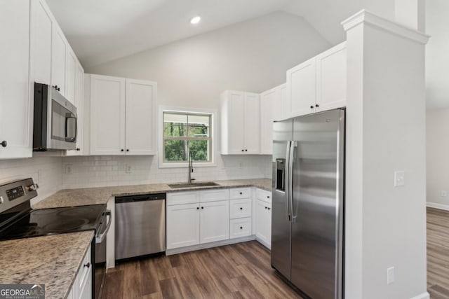3143 Lee Cir, Buford, GA 30518 - kitchen featuring vaulted ceiling, backsplash, a sink, dark wood-style floors, and appliances with stainless steel finishes