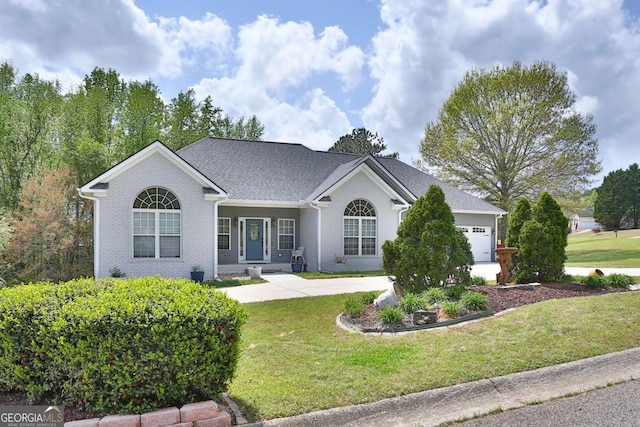 ranch-style home featuring an attached garage, brick siding, and a front lawn