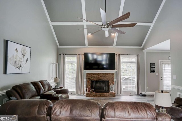 living room featuring a fireplace, high vaulted ceiling, ceiling fan, and ornamental molding