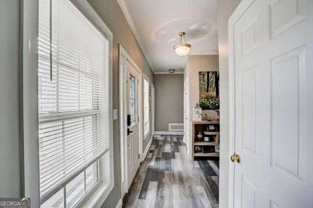 interior space featuring dark wood-style floors, visible vents, crown molding, and baseboards