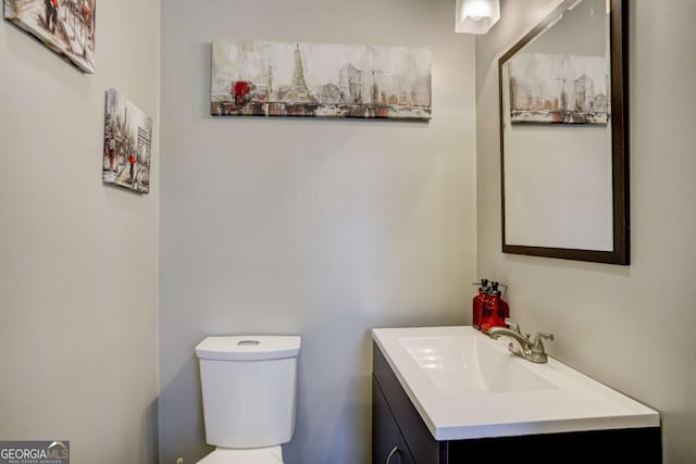 bathroom featuring toilet and vanity