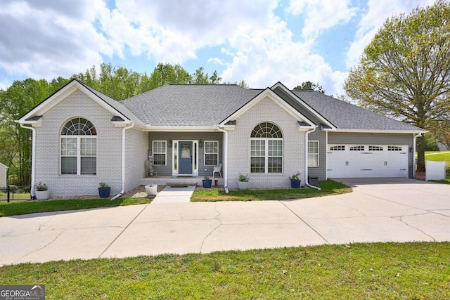 ranch-style house with an attached garage, brick siding, and concrete driveway