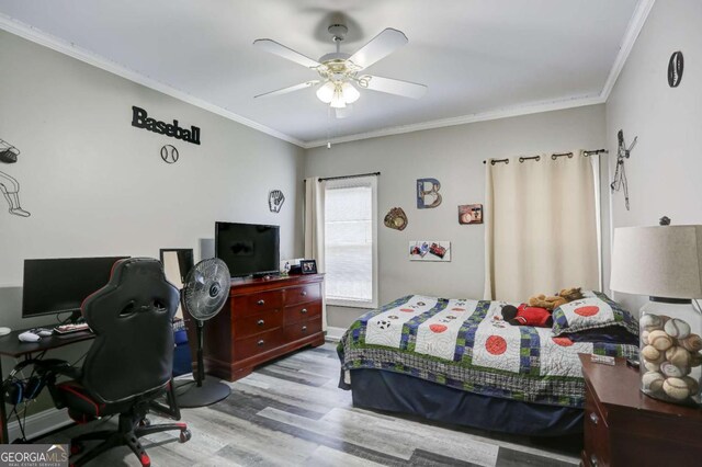bedroom featuring baseboards, ornamental molding, wood finished floors, and a ceiling fan