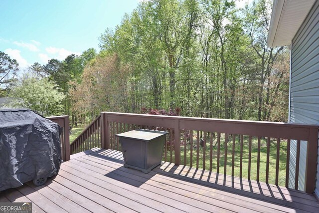 wooden deck with a view of trees