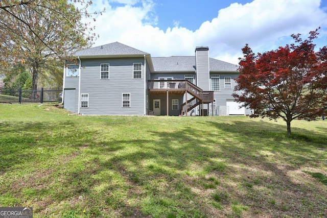 back of property with stairs, a chimney, a deck, fence, and a yard