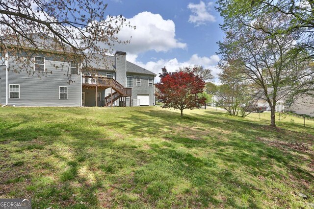 view of yard with stairs and a wooden deck