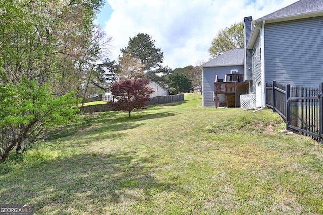view of yard with stairs, a fenced backyard, and a deck