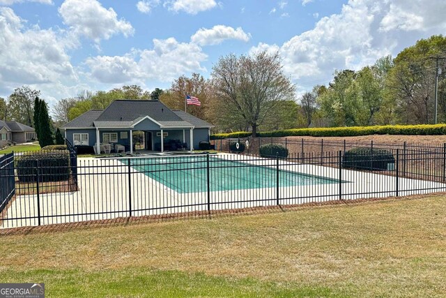 view of swimming pool with a patio, fence, a fenced in pool, and a yard