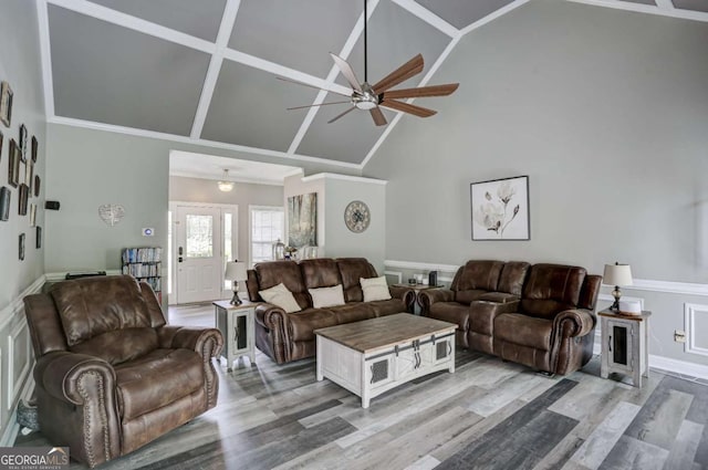 living room with crown molding, high vaulted ceiling, wood finished floors, and a ceiling fan
