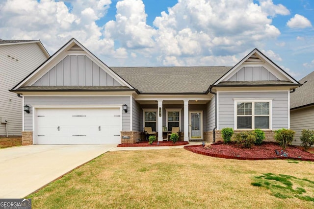 craftsman-style home with board and batten siding, driveway, a front yard, and brick siding