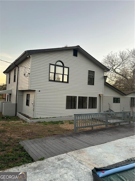 rear view of house featuring a deck