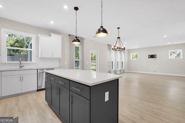 106 Canter Ct, Savannah, GA 31406 - kitchen with light wood-style flooring, light countertops, stainless steel dishwasher, and white cabinetry