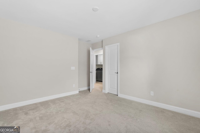106 Canter Ct, Savannah, GA 31406 - spare room featuring washer / clothes dryer, baseboards, and light colored carpet