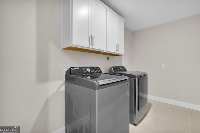 106 Canter Ct, Savannah, GA 31406 - laundry room with light tile patterned floors, baseboards, washing machine and clothes dryer, and cabinet space