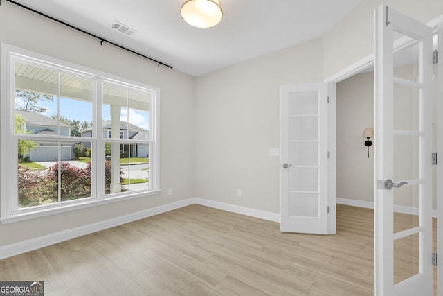 106 Canter Ct, Savannah, GA 31406 - spare room with french doors, baseboards, light wood-type flooring, and visible vents
