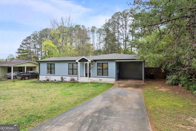 view of front facade featuring concrete driveway, fence, a front yard, an attached carport, and a shingled roof
