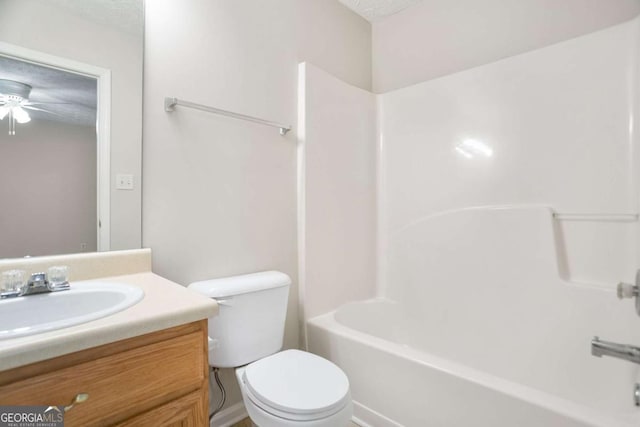 bathroom with vanity, toilet, a ceiling fan, and washtub / shower combination