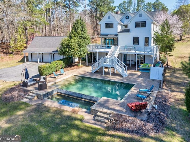 1768 Hood Rd, Dacula, GA 30019 - swimming pool featuring stairway, a wooden deck, an in-ground hot tub, and a patio