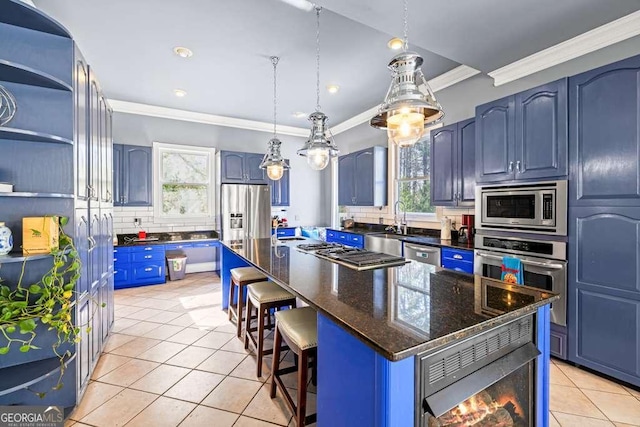 1768 Hood Rd, Dacula, GA 30019 - kitchen featuring appliances with stainless steel finishes, blue cabinets, decorative backsplash, light tile patterned floors, and a kitchen island