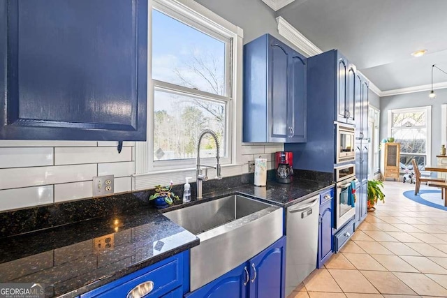 1768 Hood Rd, Dacula, GA 30019 - kitchen featuring blue cabinetry, stainless steel appliances, a sink, crown molding, and light tile patterned floors